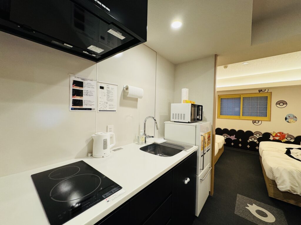 Kitchen area inside the Pokémon Room at MIMARU TOKYO UENO EAST, including a sink, fridge, and microwave.