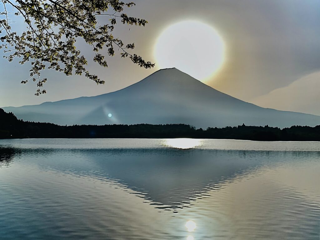 Mount Fuji reflected on Lake Tanuki at sunrise, showing the rare “Diamond Fuji”