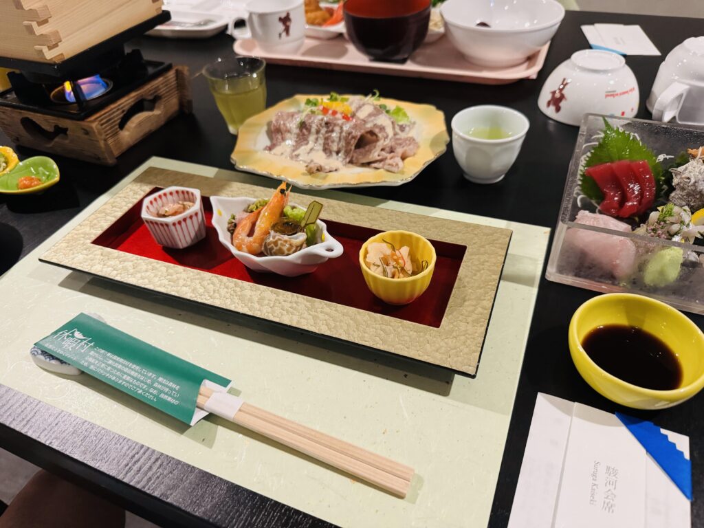 A beautifully arranged Suruga Kaiseki dinner served at Kyukamura Fuji, featuring seasonal ingredients from the Mt. Fuji area.