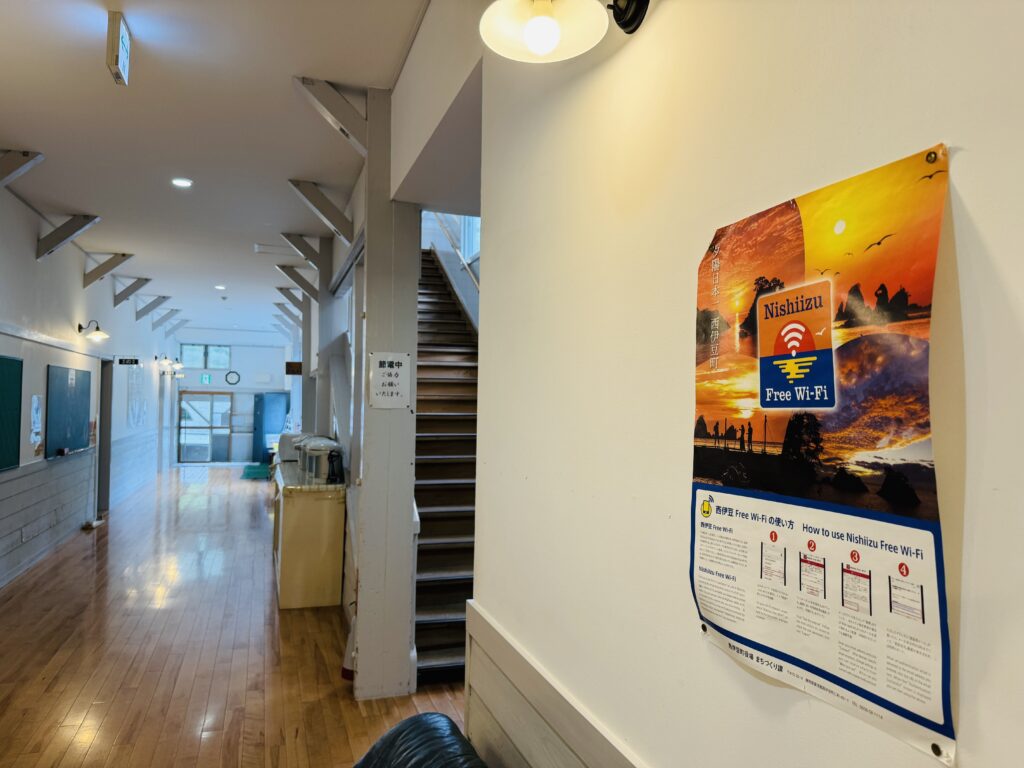 Poster in the hallway at Yamabiko-so Inn in Nishi-Izu showing information about free Wi-Fi