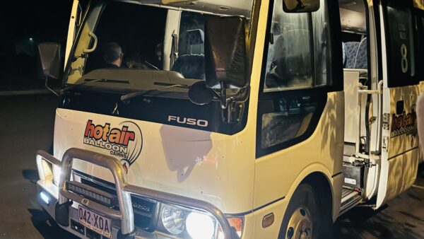Hot Air Balloon Cairns shuttle bus with the vehicle number displayed beside the door.