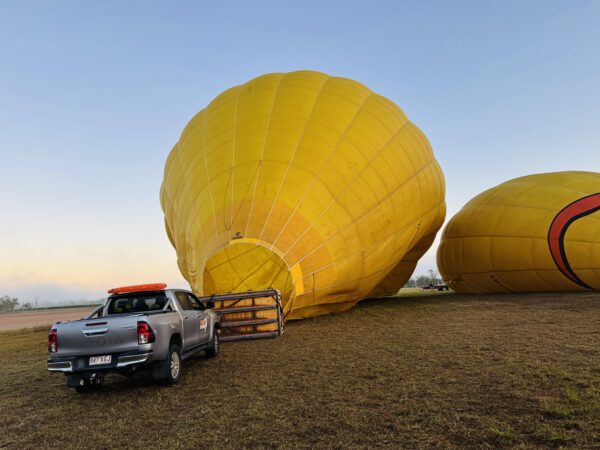 Hot air balloon being inflated with burner flames at the launch site on the Mareeba Tablelands near Cairns.