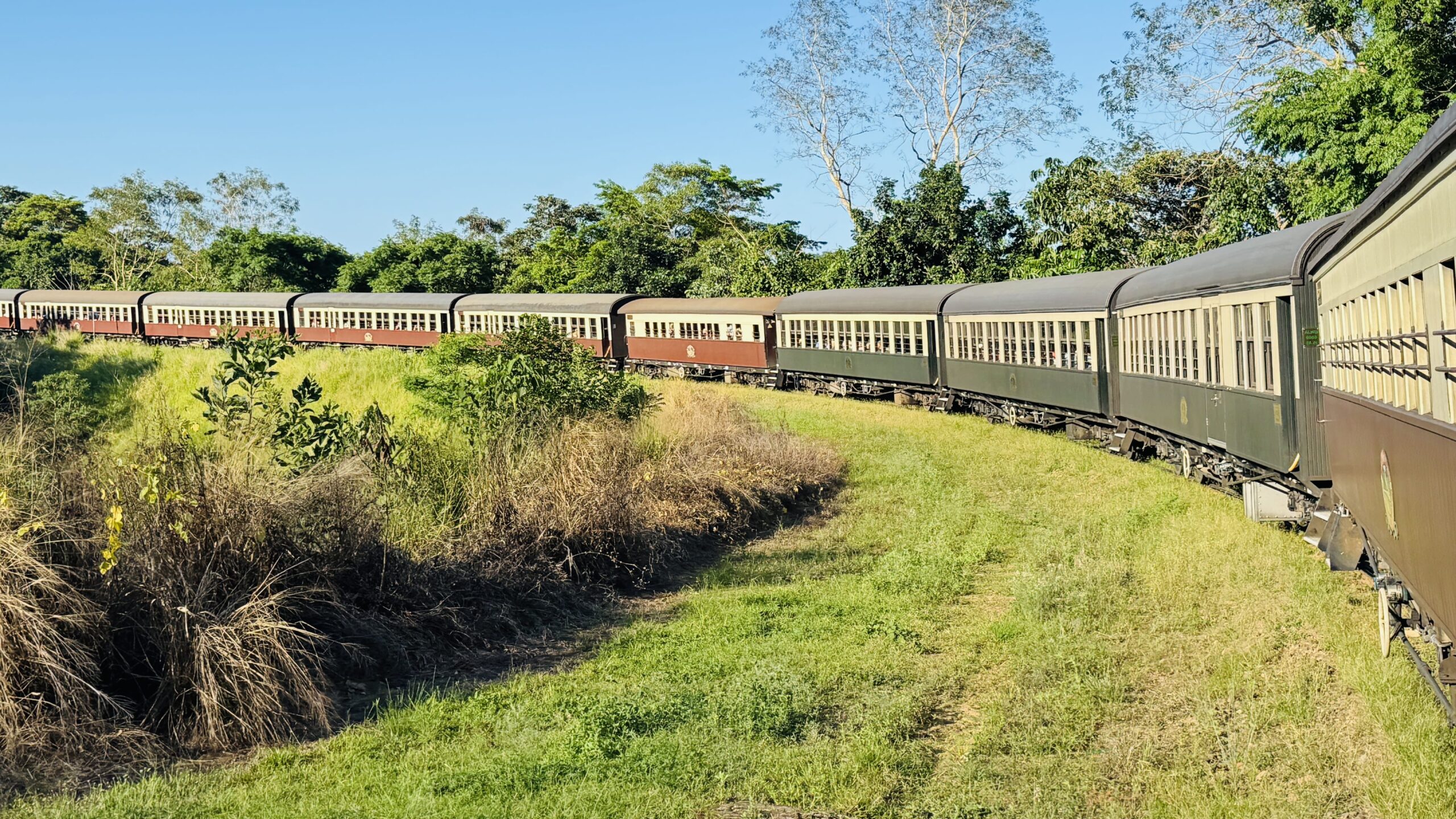 Horseshoe Bend (Jungara Loop) viewed from the Kuranda Scenic Railway window, with the train curving in a dramatic horseshoe shape along the mountainside.