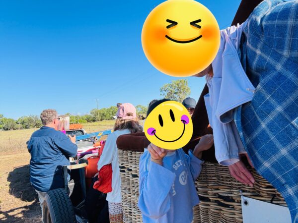 Participants riding on the trailer carrying the packed hot air balloon after the flight, heading back to the shuttle bus area.