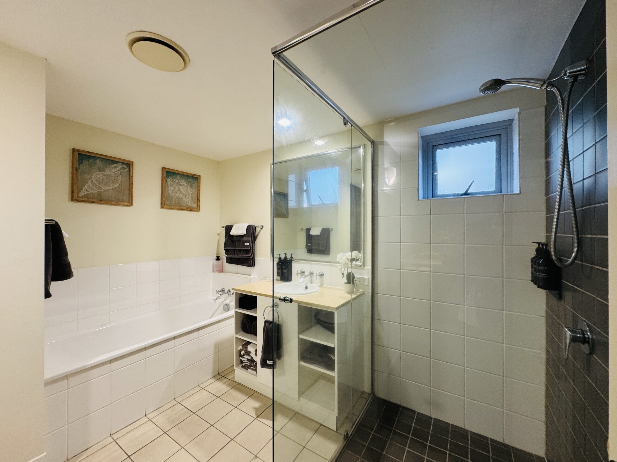 Bathroom with shower, bathtub, and sink at Cairns Reefside Retreat
